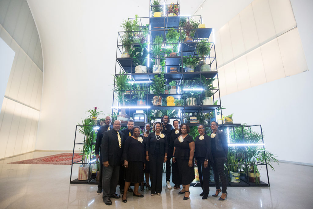 First African Baptist Church Contemporary Choir stands in front of of Rashid Johnson's "Monument" sculpture