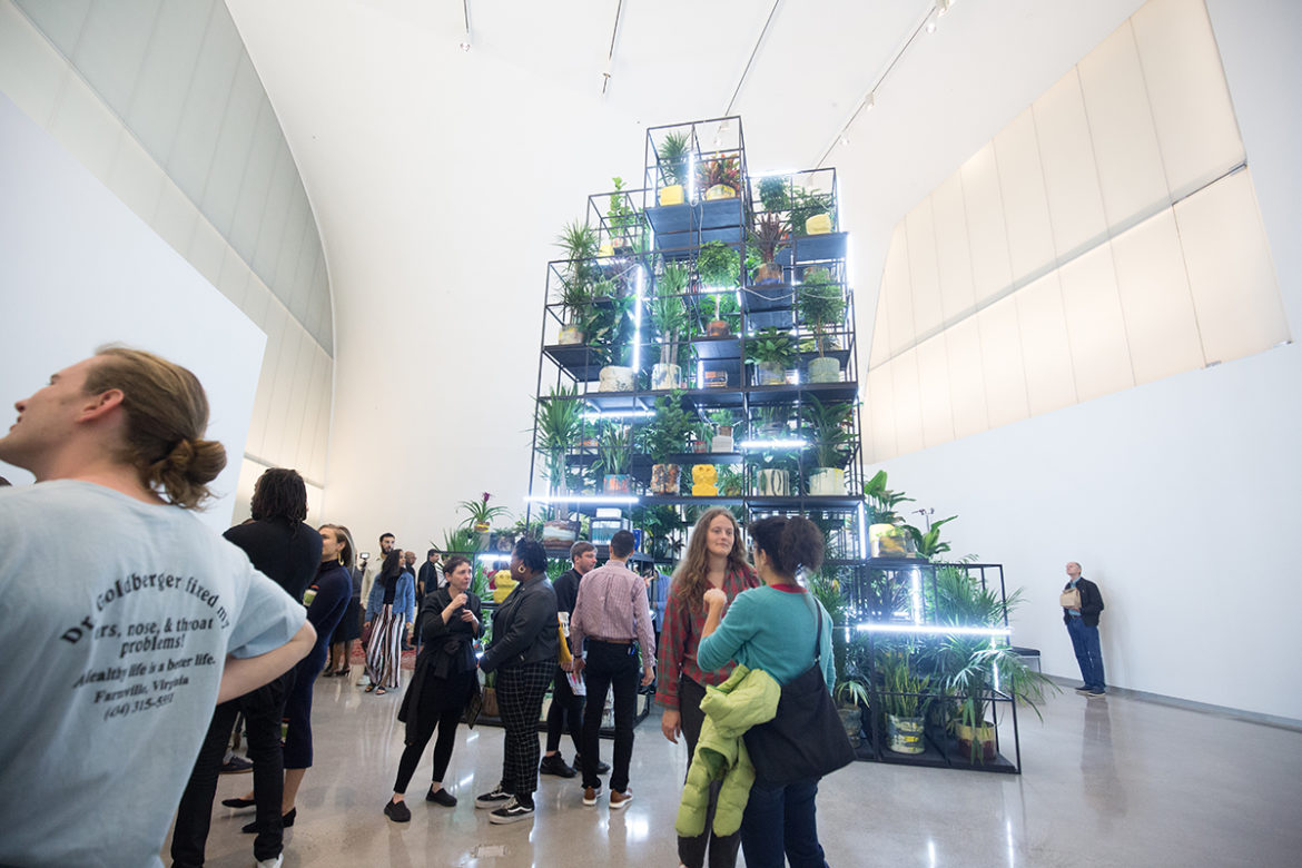 Visitors gather around Rashid Johnson's "Monument" installation