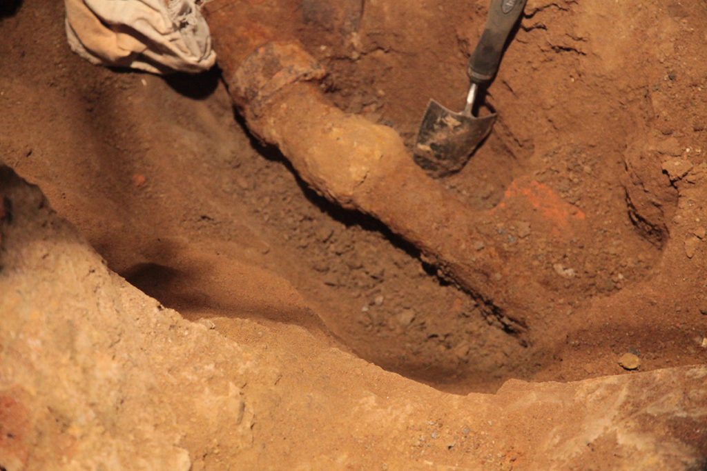 Process shot of trenches being dug beneath Corin Hewitt's home. Underground sewage pipes are slowly becoming visible.